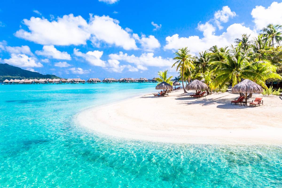 Panoramablick auf blaues Meer und weißen Sandstrand unter blauem Himmel