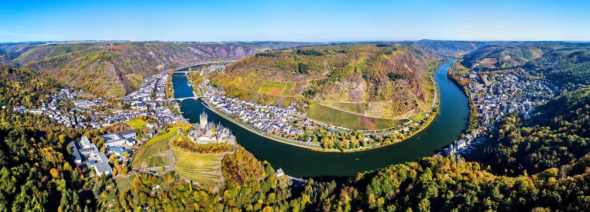 Flusskurve der Mosel mit steilen Weinbergen und blauem Himmel – idyllisches Moseltal Panorama