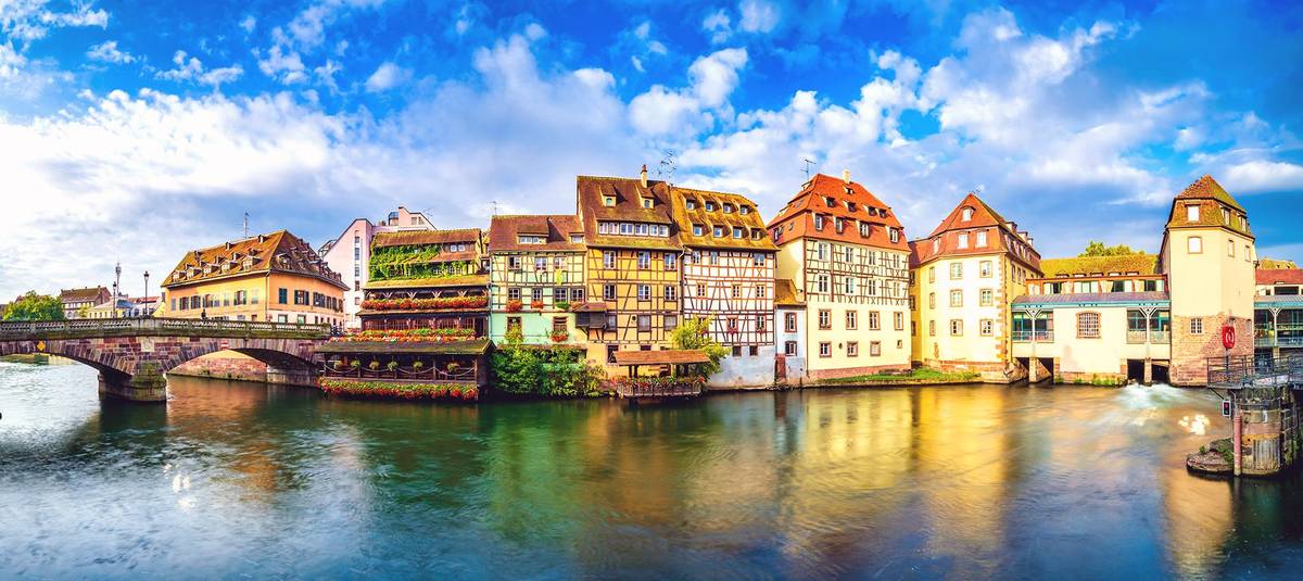Panoramablick auf das pitoreske ehemalige Gerberviertel La Petit France in Straßburg. Man sieht den Kanal, die alte Brücke und das beliebte Bístro mitten im Viertel "Kleines Frankreich"