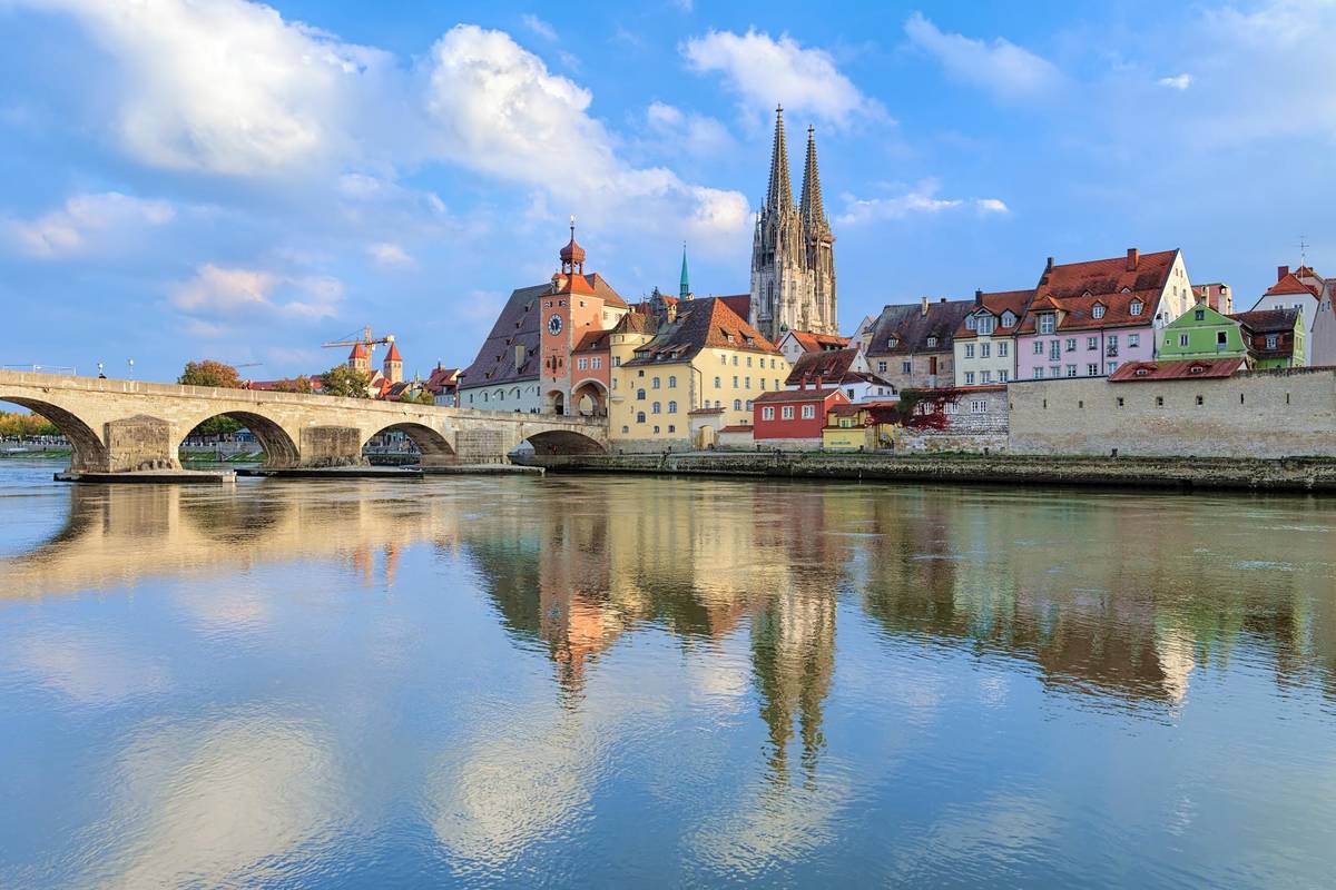 Regensburg an der Donau mit Blick auf die Steinbrücke und die Kathedrale unter blauem Himmel
